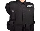 black sample vest with police patch and mag on upper chest smaller